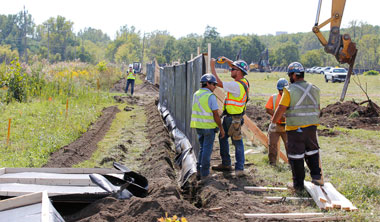 Construction workers assemble the exclusion fence