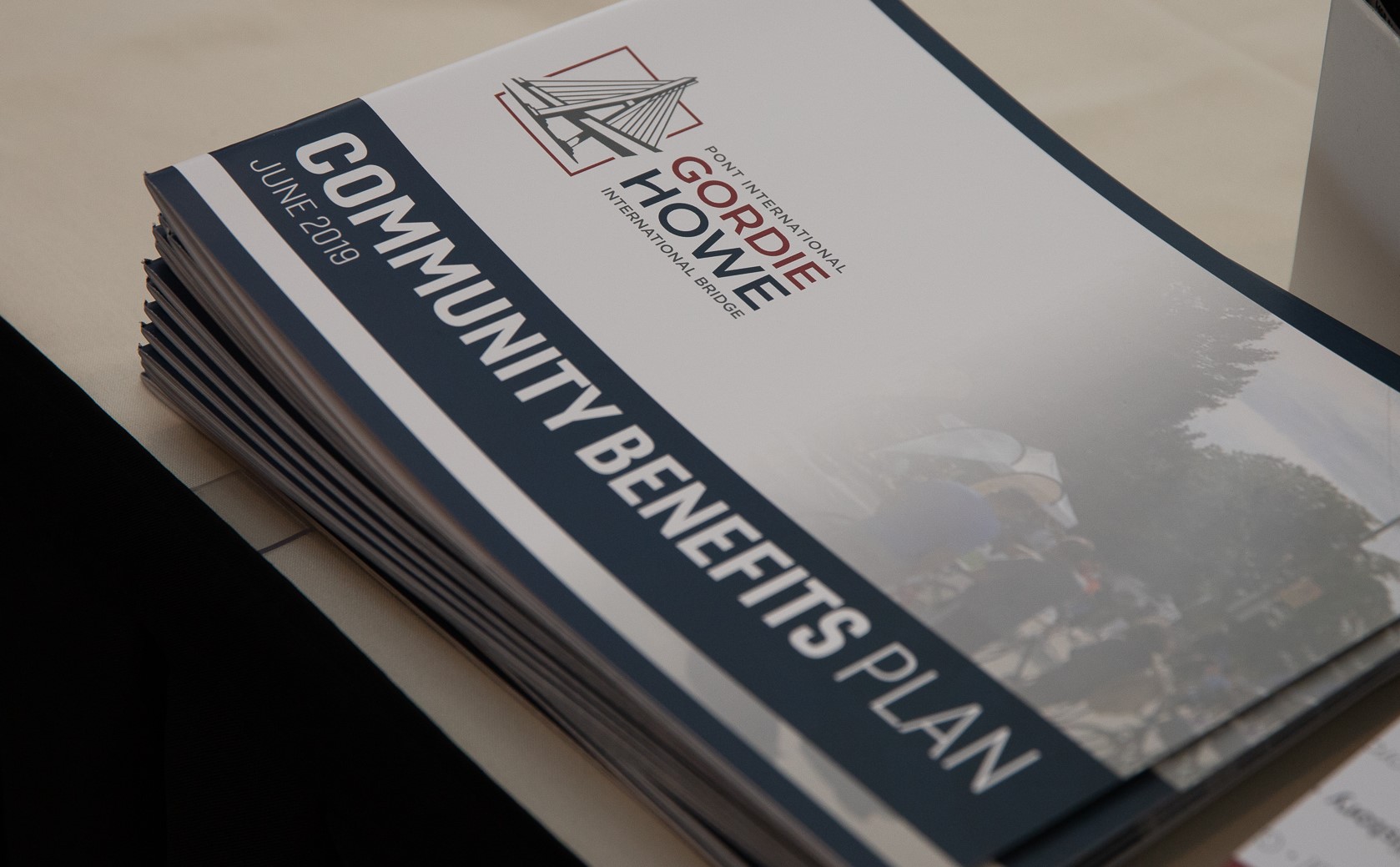 Printed stack of the Gordie Howe International Bridge Community Benefits plan