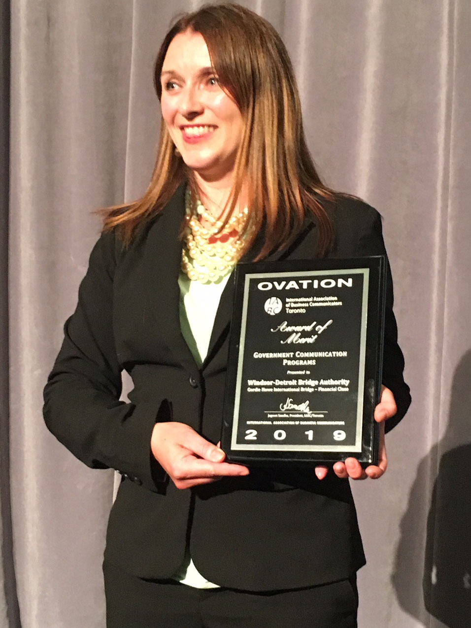 Photo of WDBA representative accepting 2019 Ovation Award which reads "Award of Merit - Government Communication Programs"