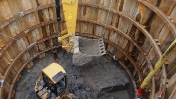 An overhead view of a yellow steam shovel digging out the new pumping station
